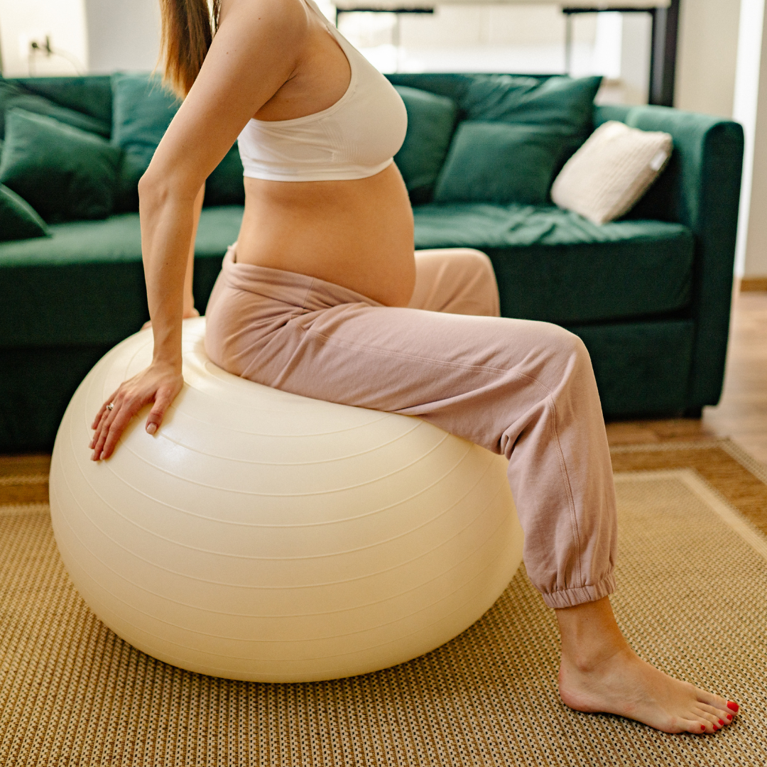 Pregnant woman preparing for labor on a birth ball