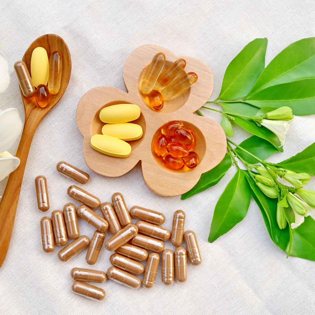 Nutritional supplements and botanicals arranged on a neutral surface