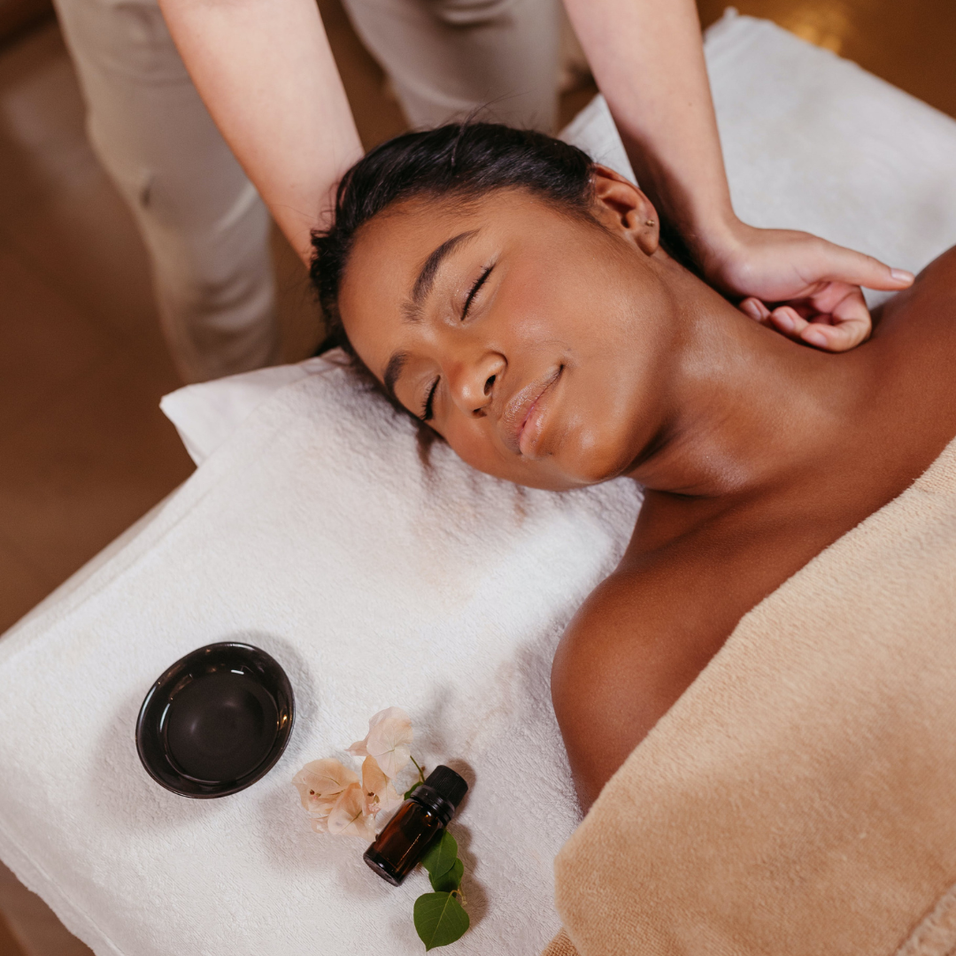 Woman receiving calming bodywork in a warm setting