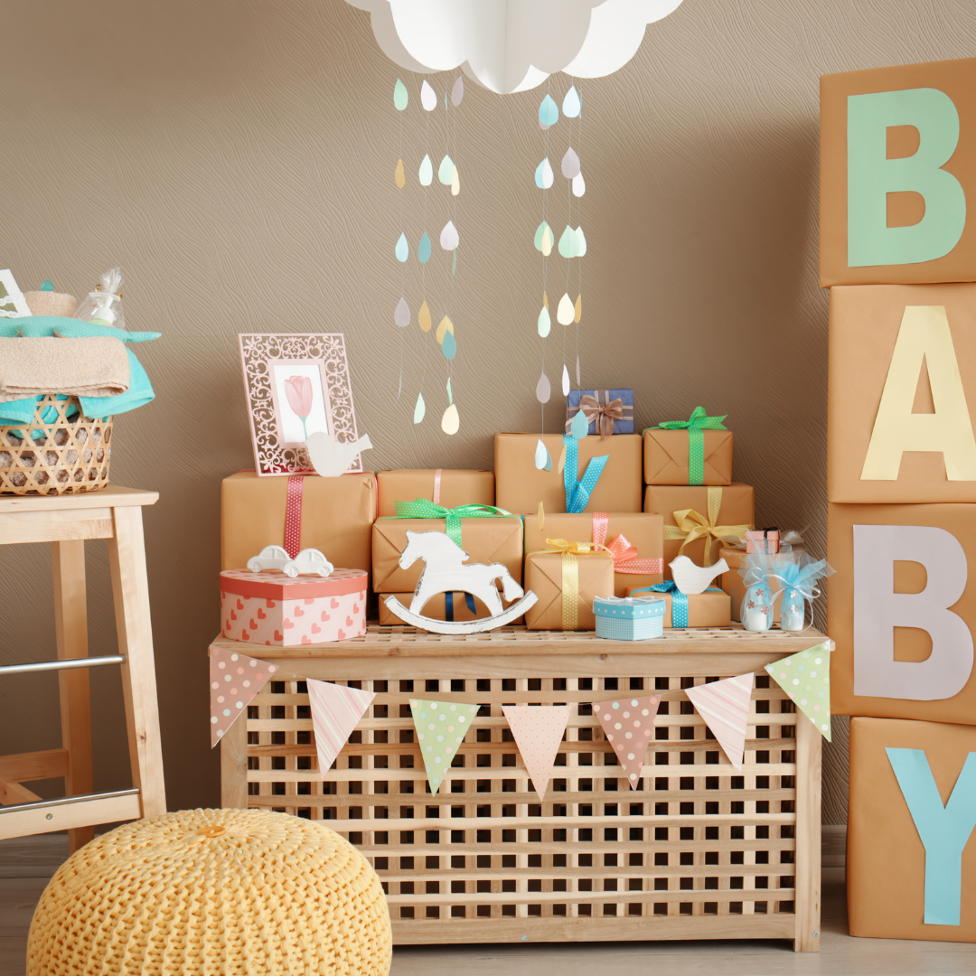 Neutral baby shower display with gifts and cloud decorations