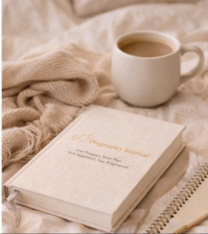 Pregnancy journal and cup of coffee on a soft blanket