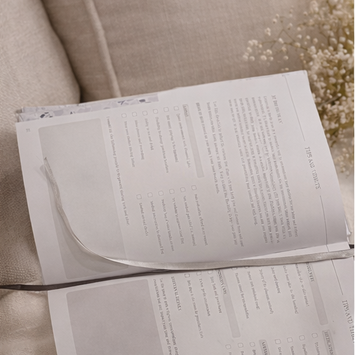 Open planner on a light-colored surface with a neutral background