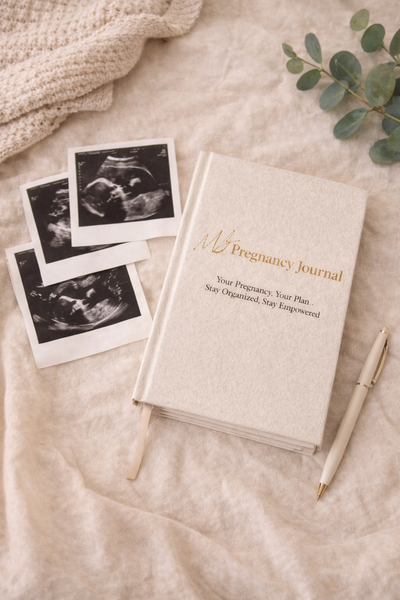 Pregnancy journal with ultrasound images on a soft surface