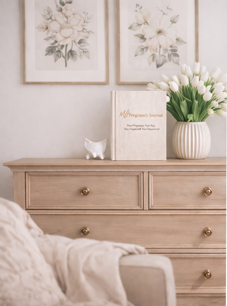 Wooden dresser with decorative items including a vase of flowers, books, and a small owl figurine.
