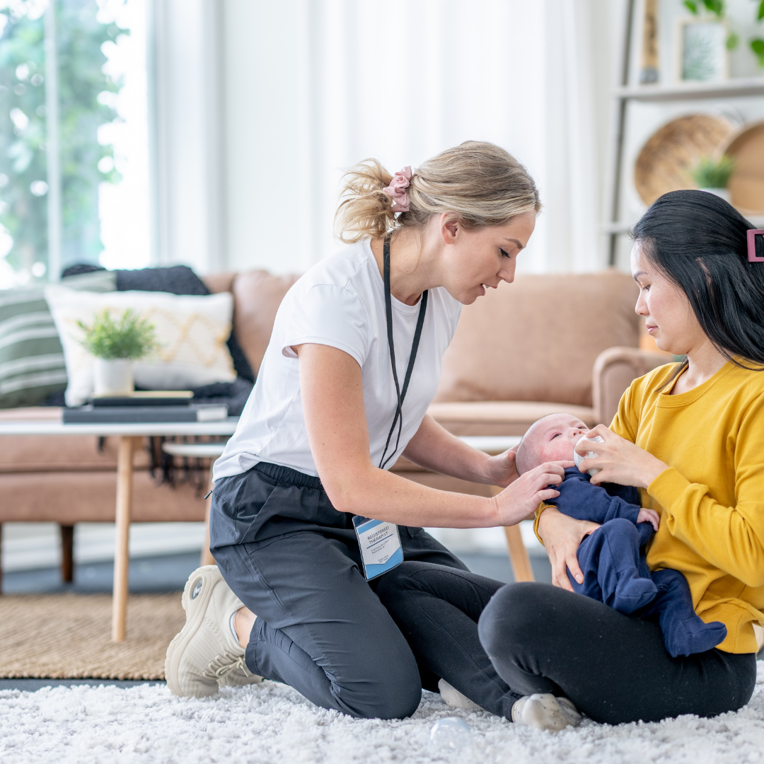 Postpartum professional supporting a mother and newborn during feeding