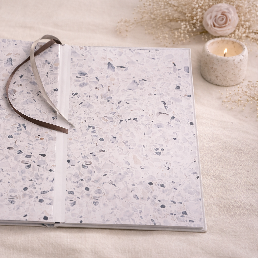 Open notebook with textured cover on a light background